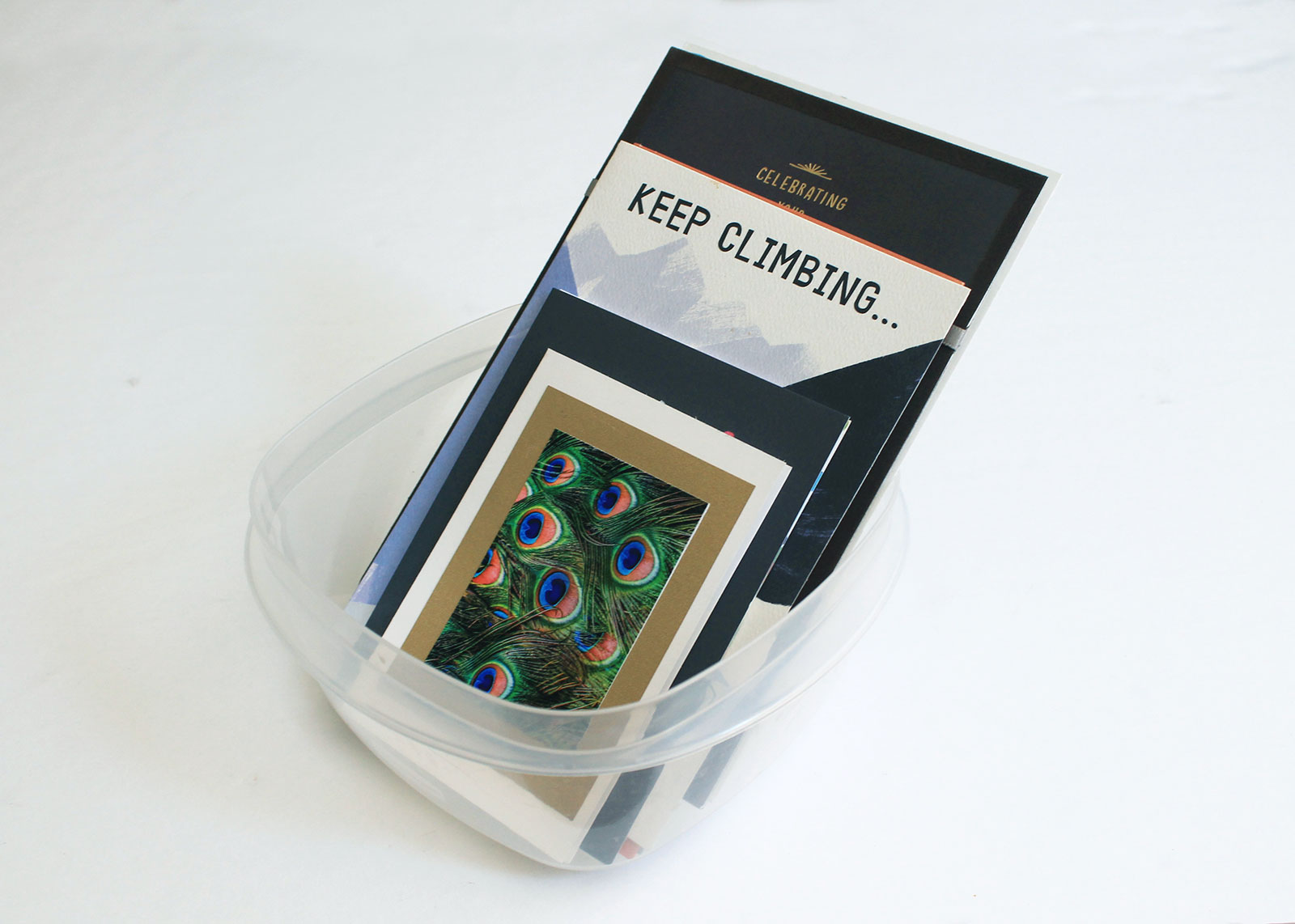 Repurpose plastic containers to store cards or mementos