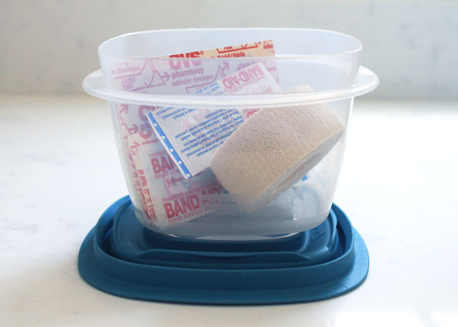 Repurpose plastic containers to store first aid kits