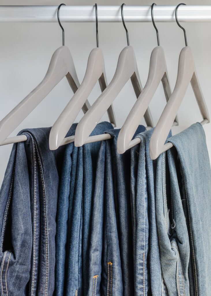 Row of blue jeans on hangers - How to Organize Jeans