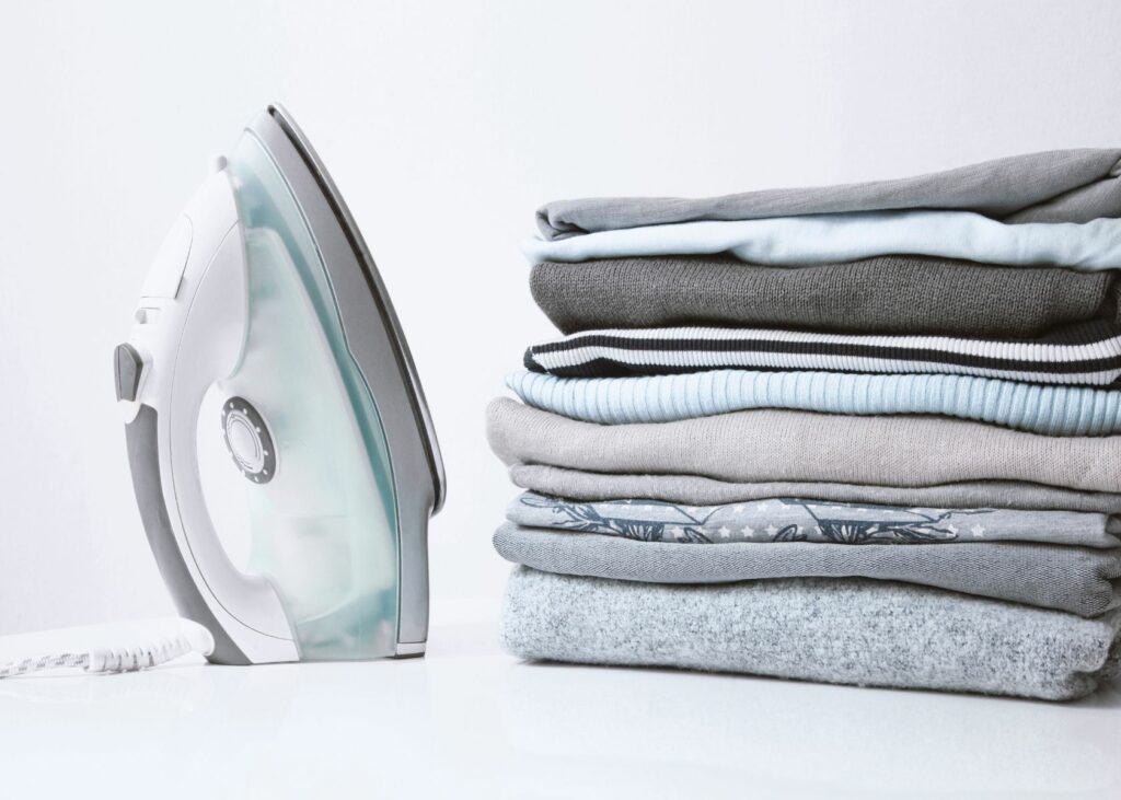 Iron and clothes on ironing board - steam iron vs. dry iron